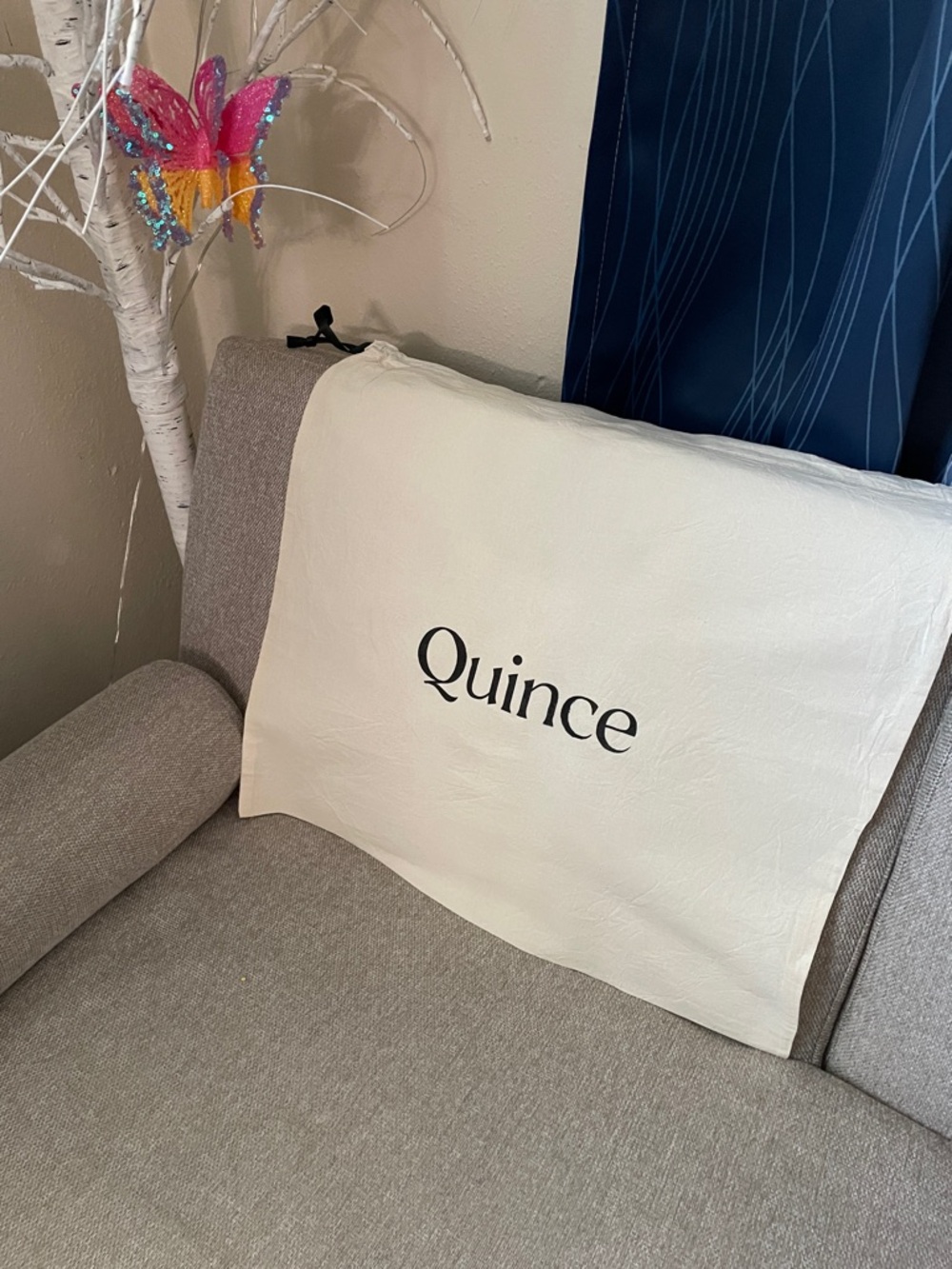 Quince Cream with black logo dust bag size 18”long 20” wide